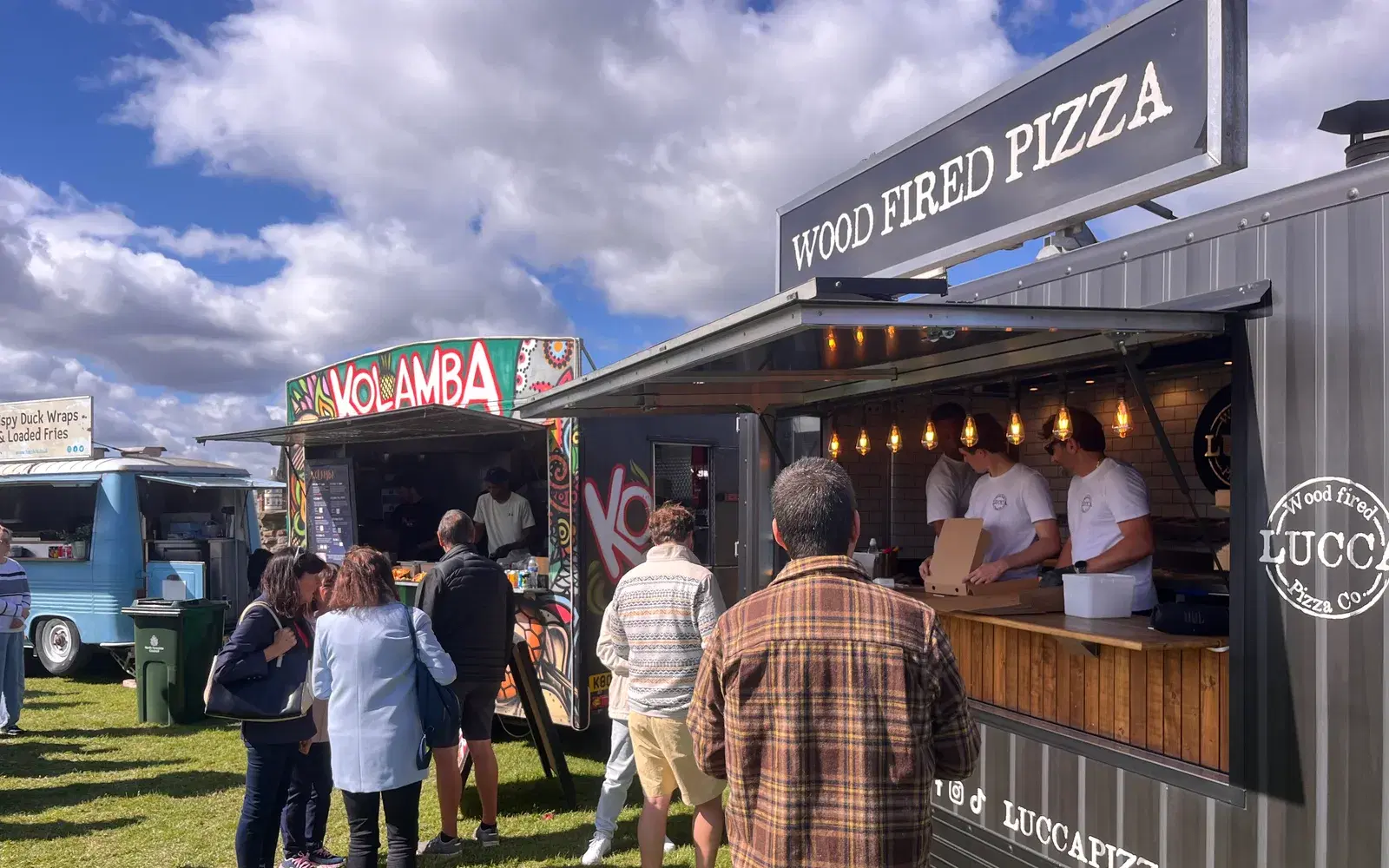 Street-food traders lined up on the headland, from wood-fired pizza to Sri Lankan food.